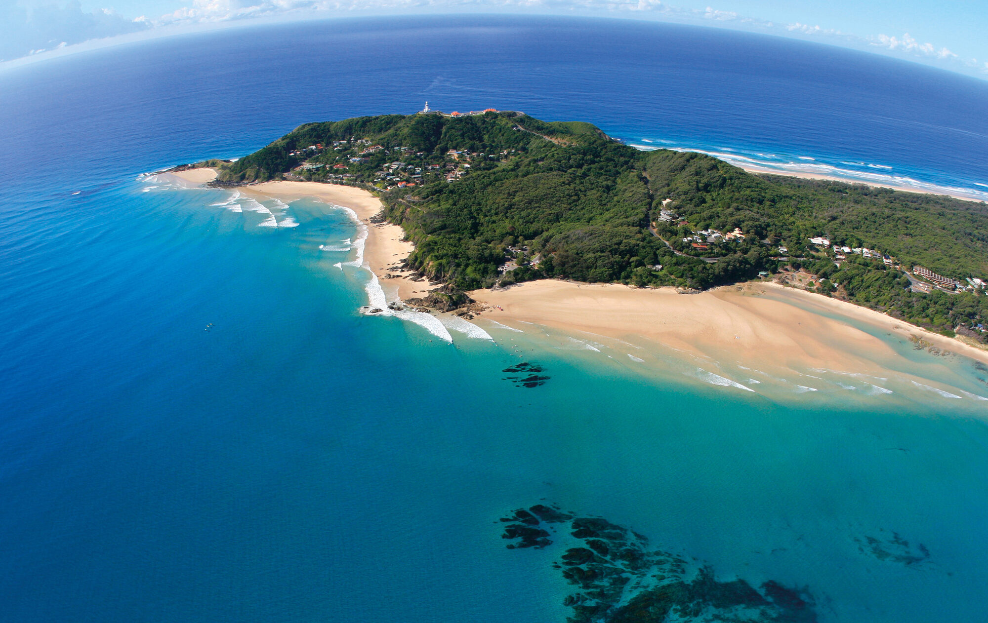 Aerial view of Cape Byron, the lighthouse and the beaches either side of the headland